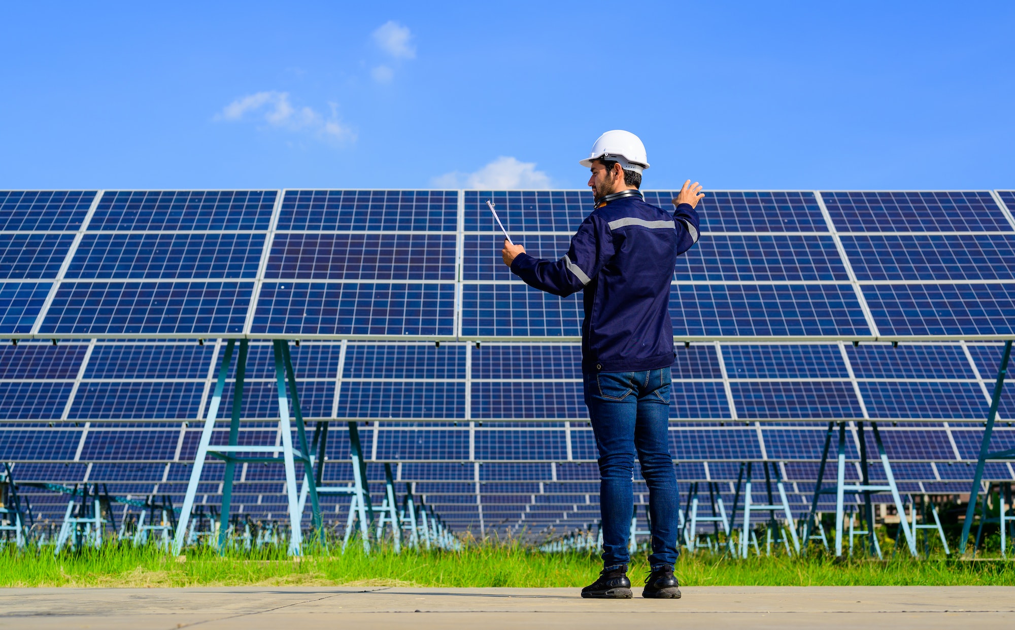 Engineer worker portrait with solar panel at solar farm